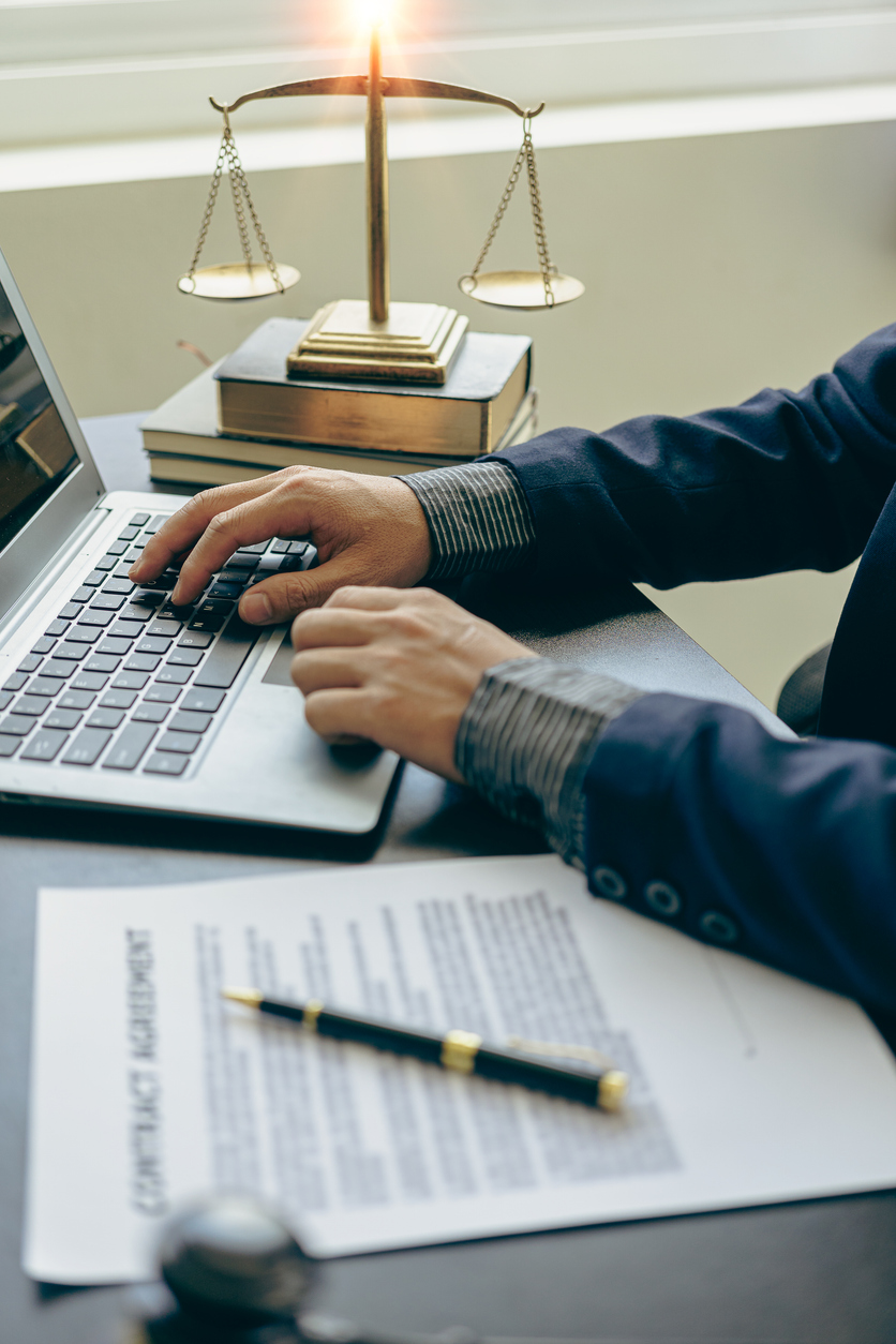 Judge hammer with judge, lawyer, businessman in suit working on legal documents in courtroom, justice and law, lawyer, judge, court concept vertical picture Bienestar